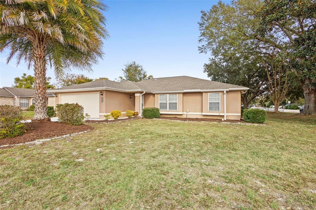 1031 Abeline Drive Deltona, FL 32725 - Photo 2 of 37 a front view of a house with a garden