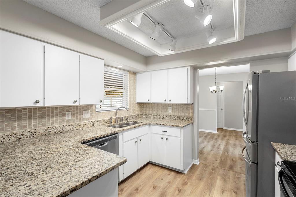 1031 Abeline Drive Deltona, FL 32725 - Photo 21 of 37 a kitchen with a sink stove and cabinets