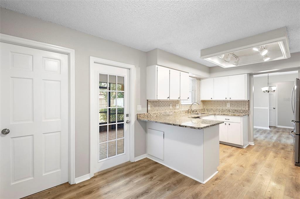 1031 Abeline Drive Deltona, FL 32725 - Photo 22 of 37 a kitchen with a sink stove and cabinets