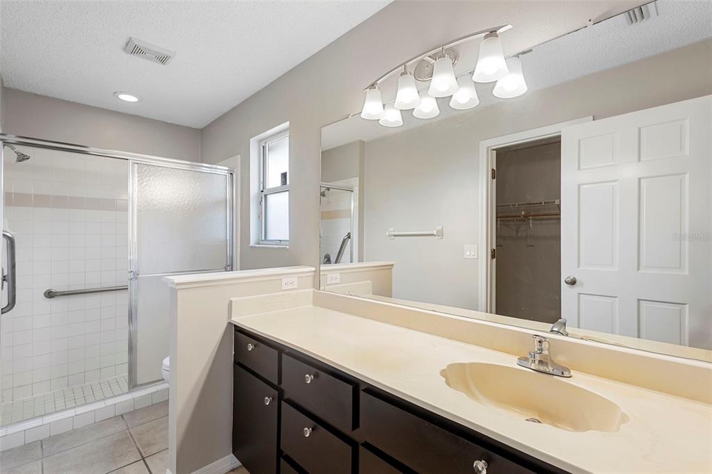 1031 Abeline Drive Deltona, FL 32725 - Photo 28 of 37 a bathroom with a sink double vanity and shower