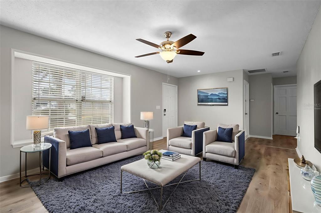 1031 Abeline Drive Deltona, FL 32725 - Photo 3 of 37 a living room with furniture and a large window