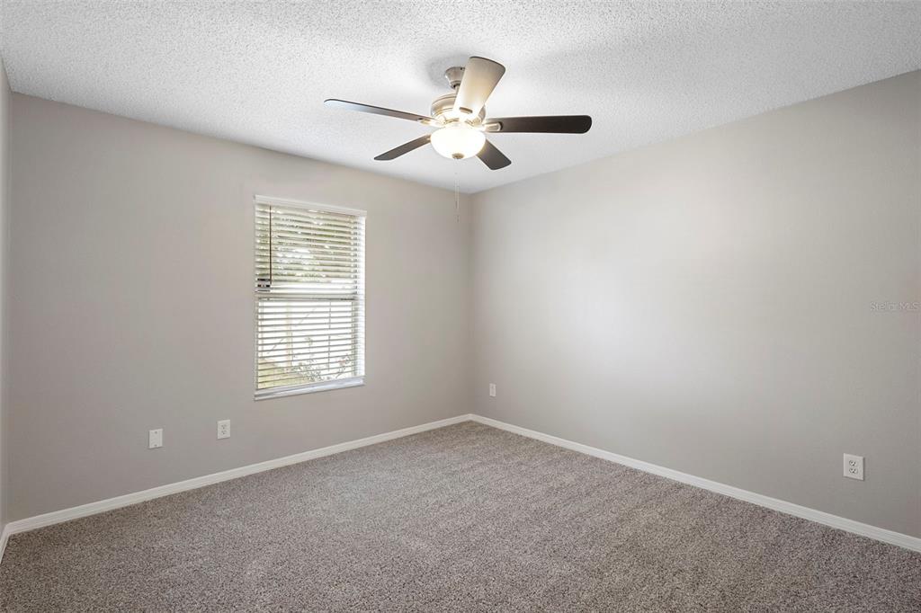 1031 Abeline Drive Deltona, FL 32725 - Photo 31 of 37 an empty room with windows and fan