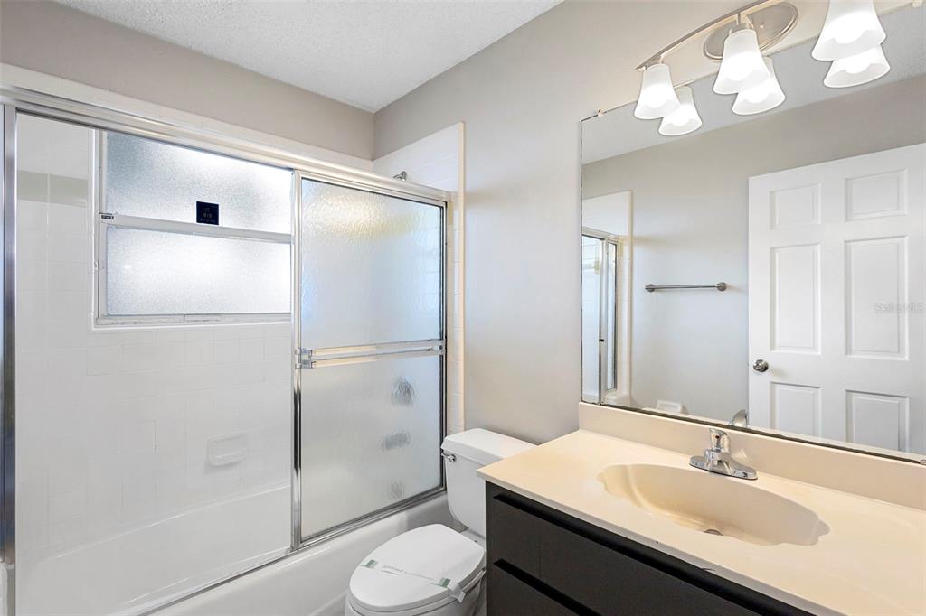 1031 Abeline Drive Deltona, FL 32725 - Photo 32 of 37 a bathroom with a sink toilet and shower