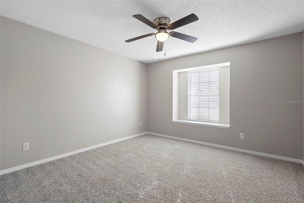 1031 Abeline Drive Deltona, FL 32725 - Photo 33 of 37 an empty room with a window and a fan