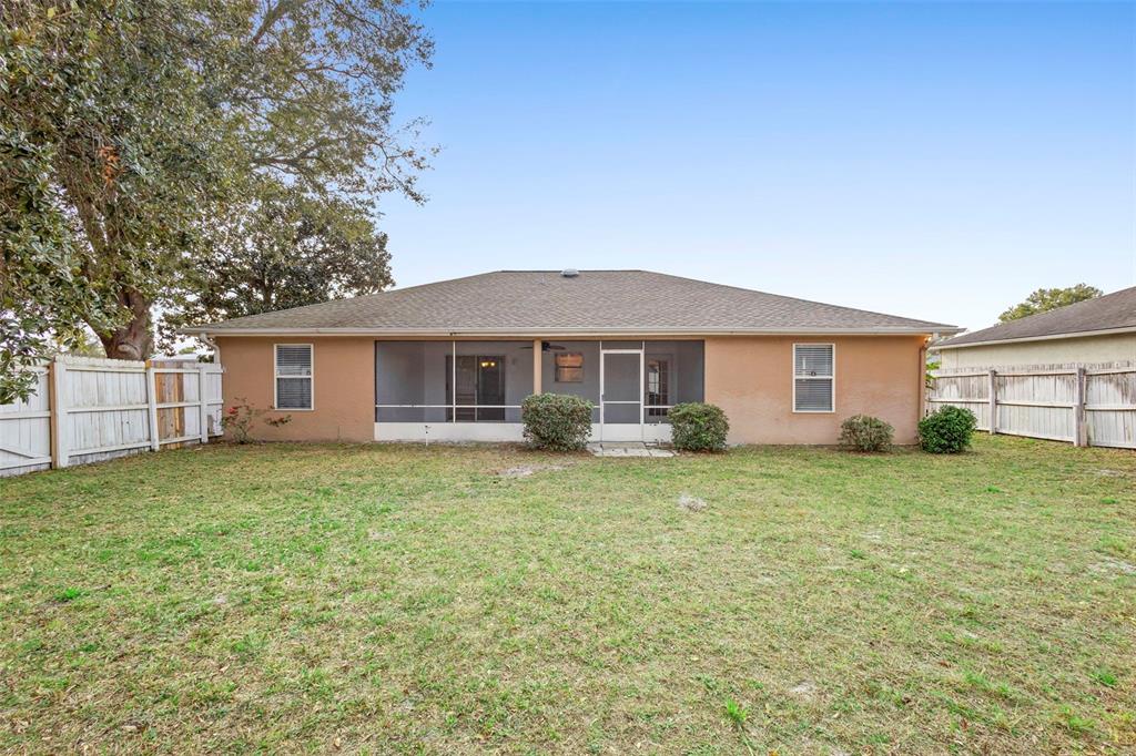 1031 Abeline Drive Deltona, FL 32725 - Photo 36 of 37 a front view of a house with a garden