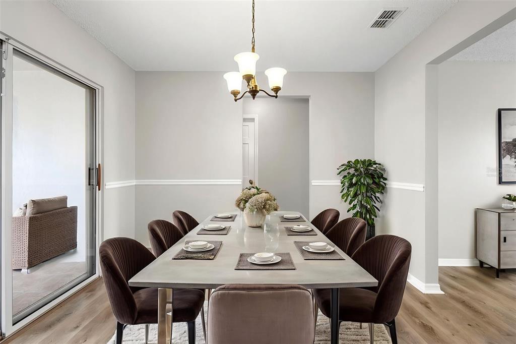 1031 Abeline Drive Deltona, FL 32725 - Photo 4 of 37 a view of a dining room with furniture and wooden floor