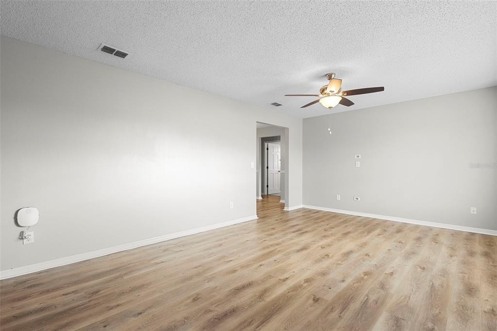 1031 Abeline Drive Deltona, FL 32725 - Photo 10 of 37 a view of an empty room with a chandelier fan