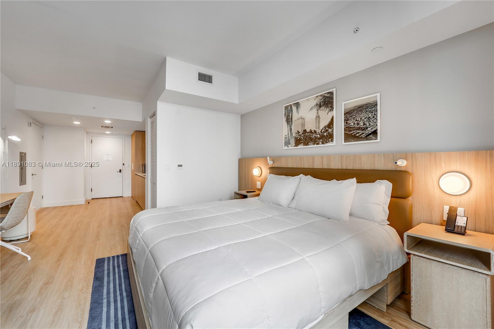 601 Northeast 1st Avenue, Unit 1619 Miami, FL 33132 - Photo 11 of 17 a bedroom with a bed and a lamp