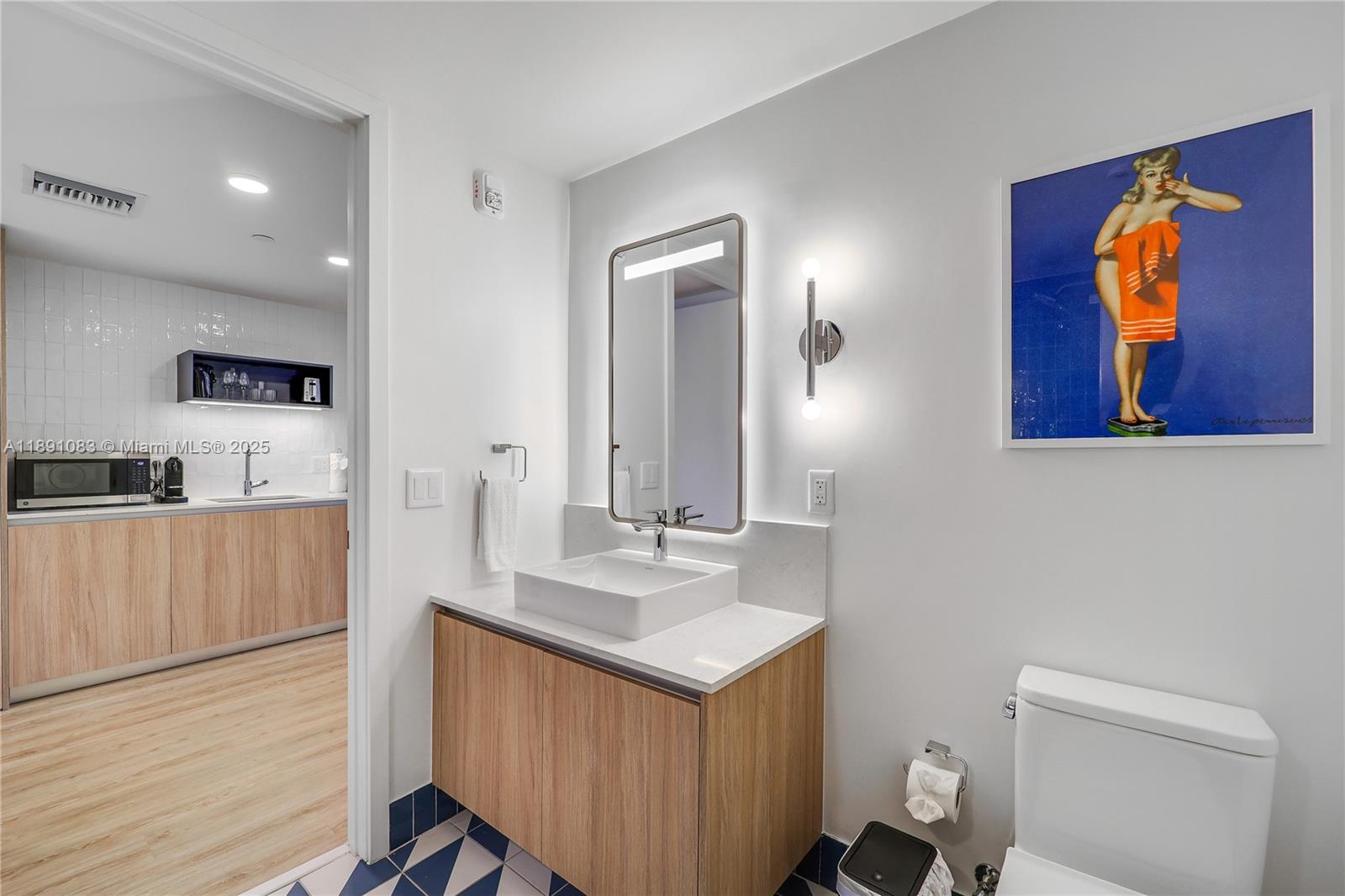 601 Northeast 1st Avenue, Unit 1619 Miami, FL 33132 - Photo 5 of 17 a bathroom with a sink a toilet and mirror