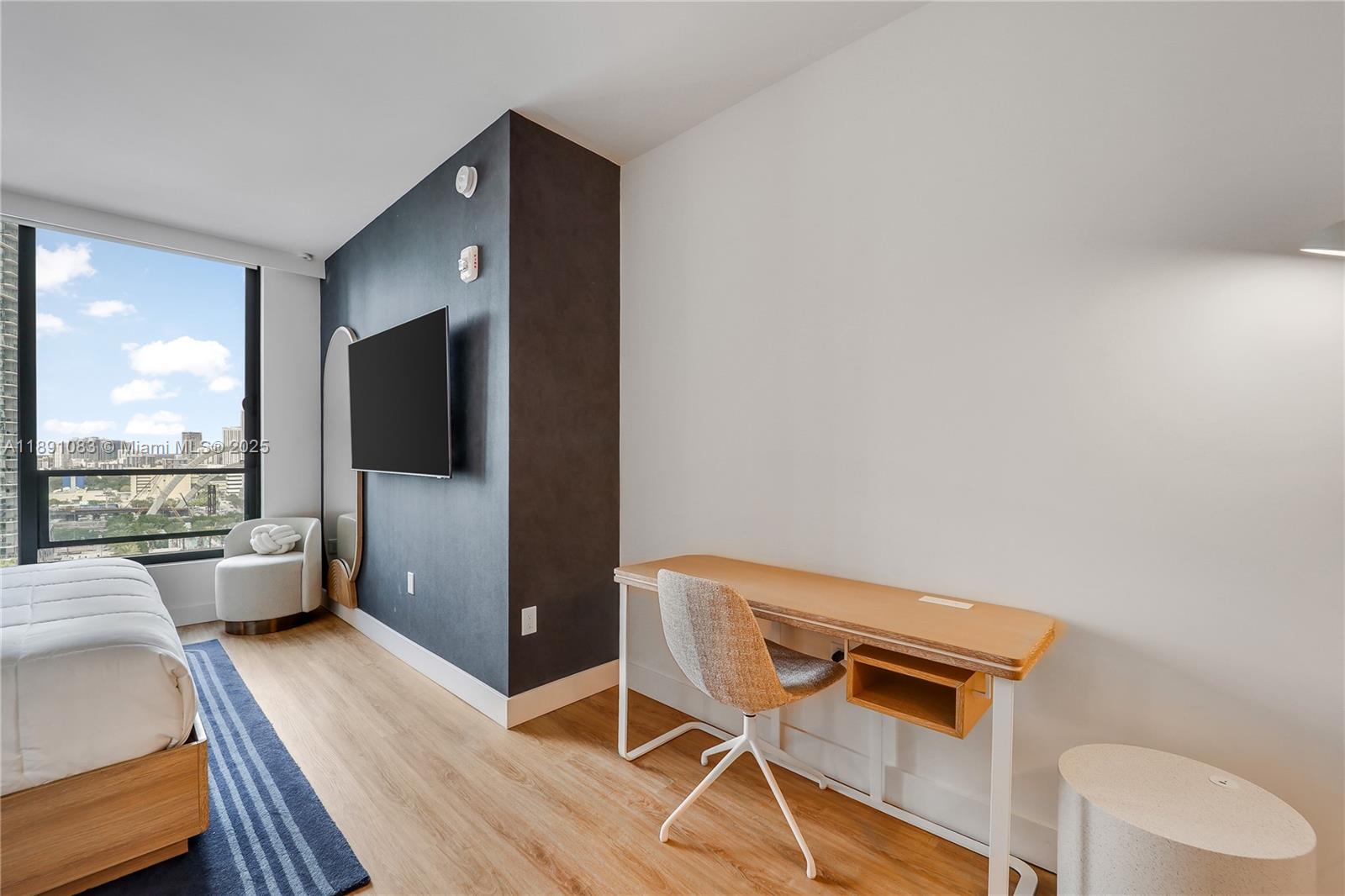 601 Northeast 1st Avenue, Unit 1619 Miami, FL 33132 - Photo 7 of 17 a living room with a couch and a flat screen tv