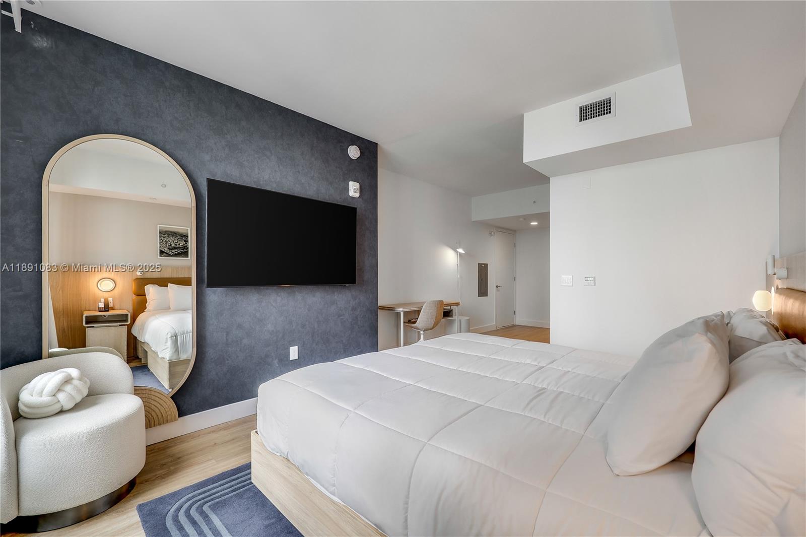 601 Northeast 1st Avenue, Unit 1619 Miami, FL 33132 - Photo 10 of 17 a bedroom with a bed and a couch