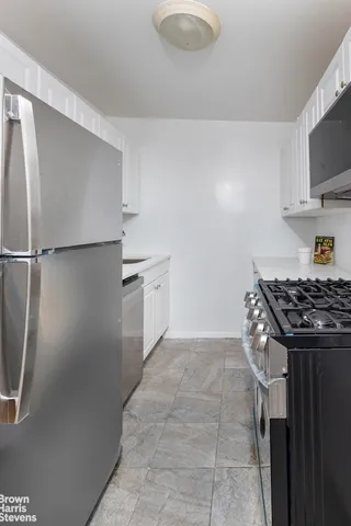 a kitchen with a stove a refrigerator and a sink