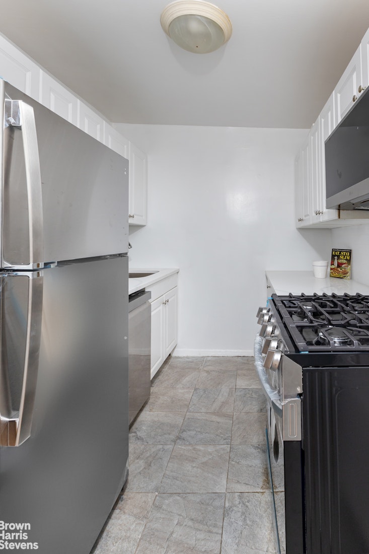 3671 Hudson Manor Terrace, Unit 4F Bronx, NY 10463 - Photo 6 of 14 a kitchen with a stove a refrigerator and a sink