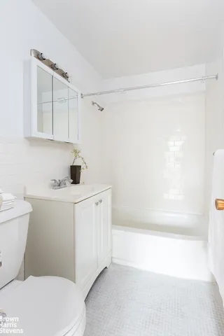 a bathroom with a sink a toilet and bathtub