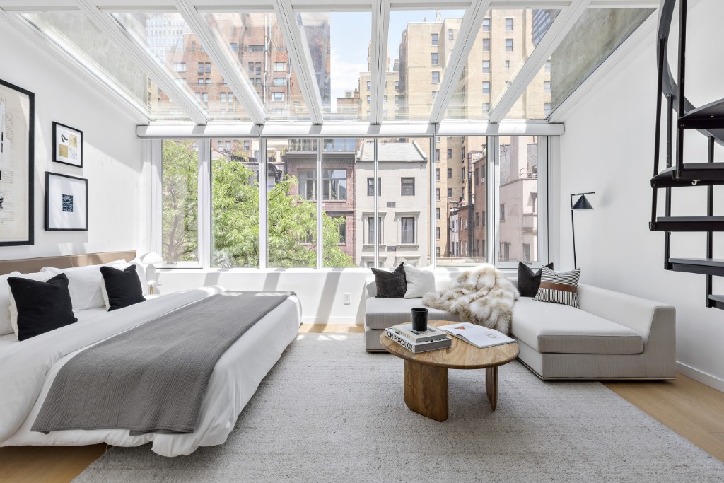 128 East 38th Street, Unit 1 Manhattan, NY 10016 - Photo 1 of 27 a spacious bedroom with furniture and a large window