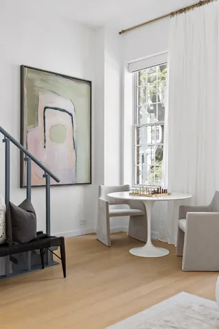 a living room with a couch and a potted plant