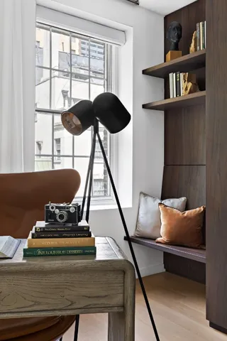 a reading room with furniture and a book shelf