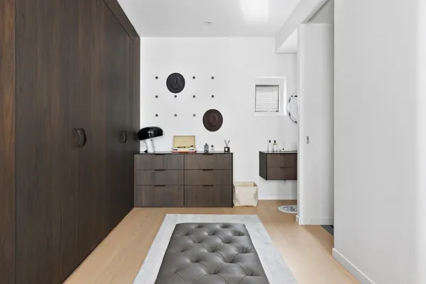a bedroom with a large bed and a dresser