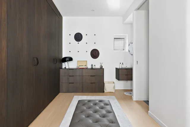 a bedroom with a large bed and a dresser