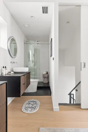 a bathroom with a sink double vanity and a mirror