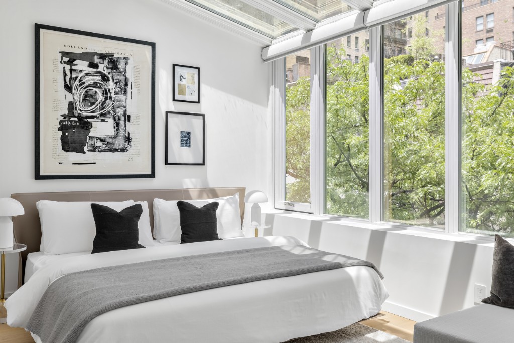 128 East 38th Street, Unit 1 Manhattan, NY 10016 - Photo 19 of 27 a bedroom with a large bed and a large window with the outer view