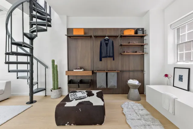 a living room with furniture and a mirror