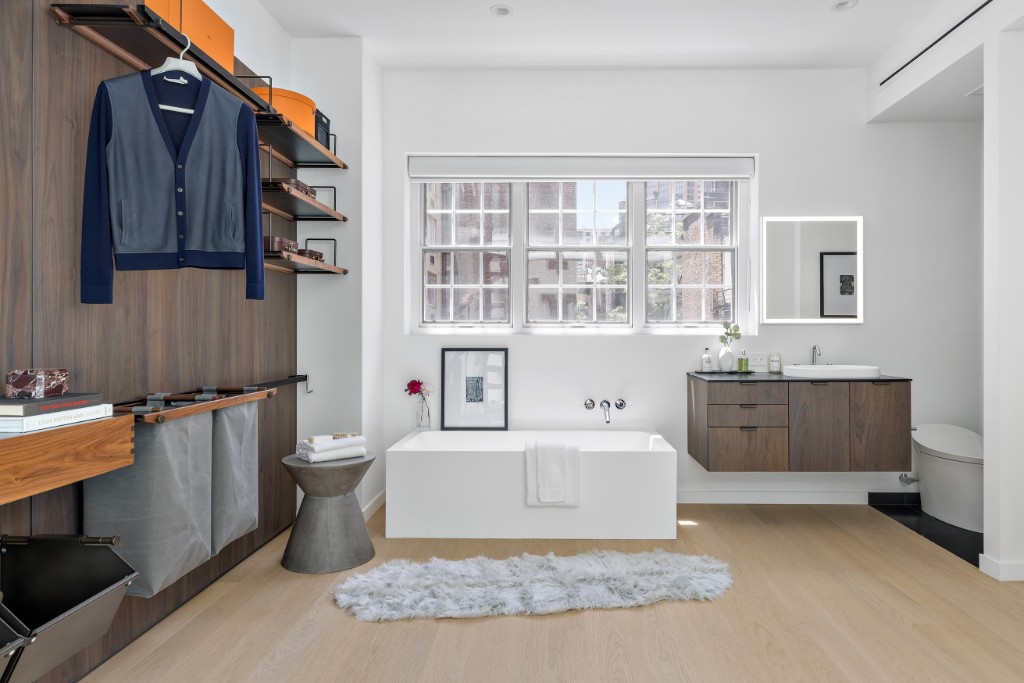 128 East 38th Street, Unit 1 Manhattan, NY 10016 - Photo 22 of 27 a living room with furniture a rug and a window