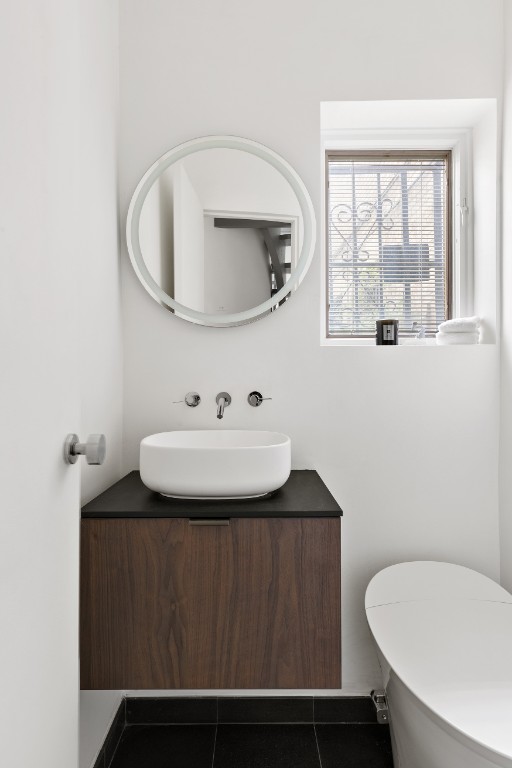 128 East 38th Street, Unit 1 Manhattan, NY 10016 - Photo 25 of 27 a bathroom with a sink toilet and mirror