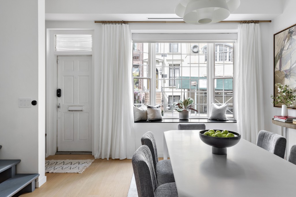 128 East 38th Street, Unit 1 Manhattan, NY 10016 - Photo 3 of 27 a view of a dining room with furniture a chandelier and wooden floor