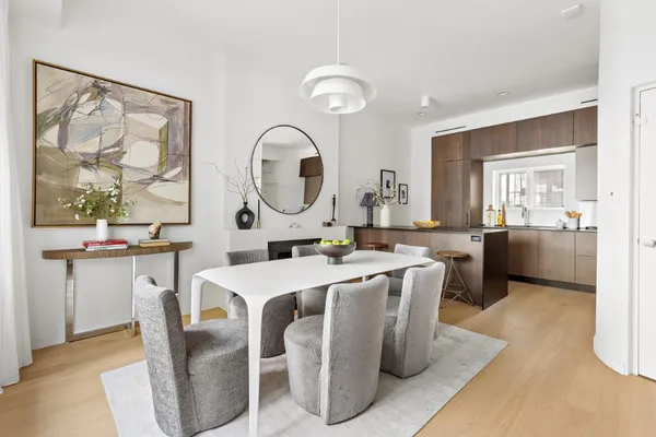 a large kitchen with a table and chairs
