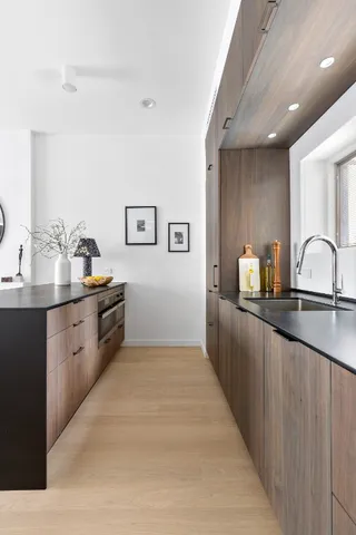 a kitchen with granite countertop a sink and cabinets