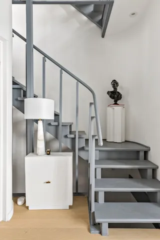 a view of living room with furniture and wooden floor