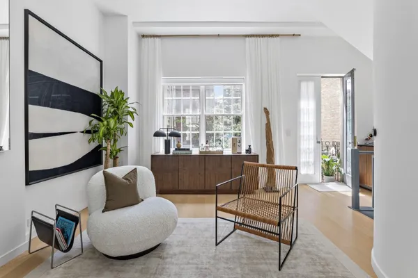a living room with furniture and a potted plant