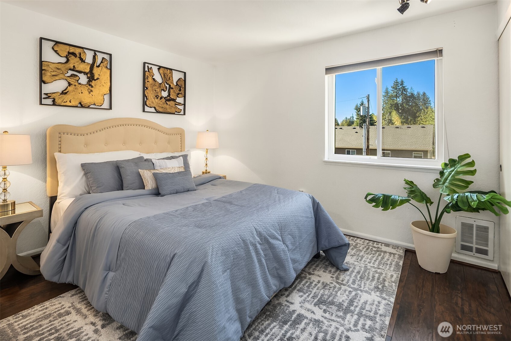 8603 244th Street Southwest, Unit 2D Edmonds, WA 98026 - Photo 16 of 21 a bedroom with a bed and painting on the wall