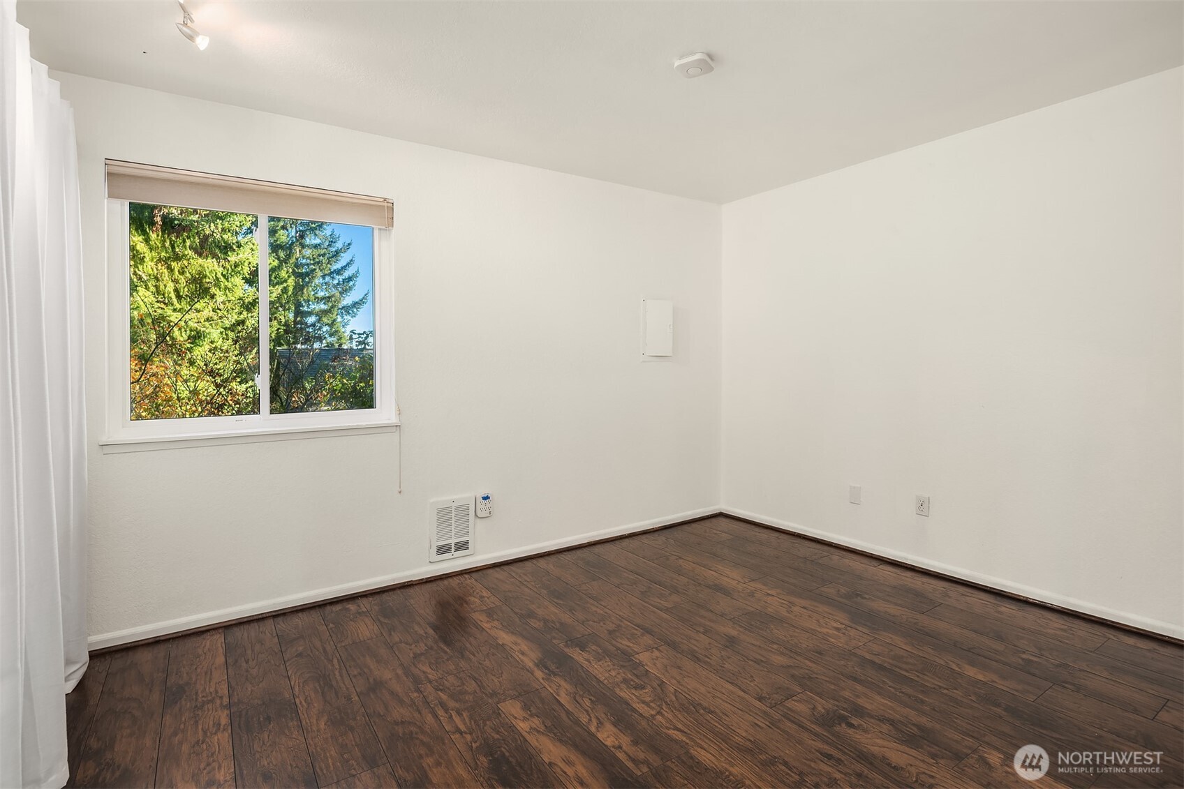 8603 244th Street Southwest, Unit 2D Edmonds, WA 98026 - Photo 19 of 21 an empty room with wooden floor and windows