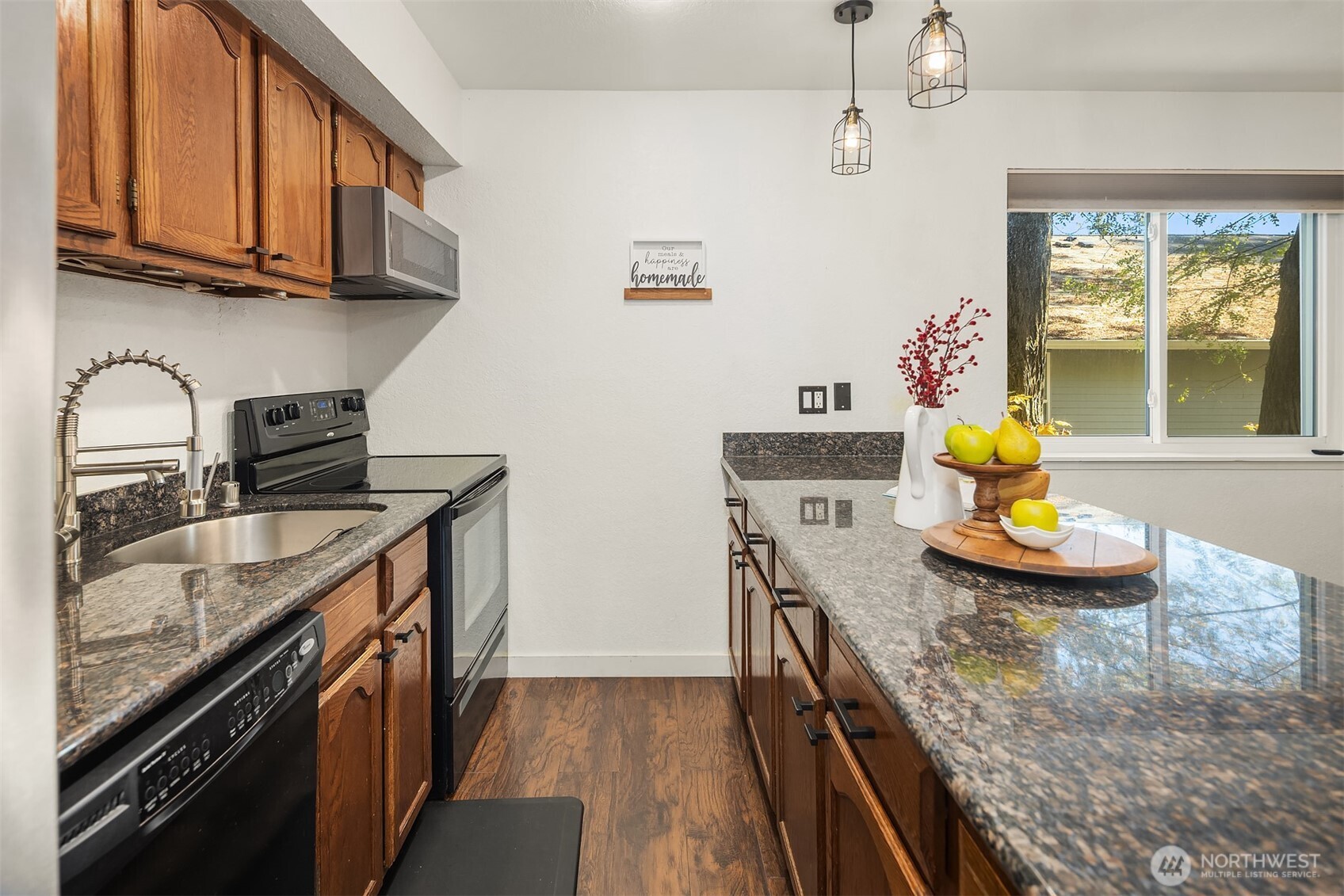 8603 244th Street Southwest, Unit 2D Edmonds, WA 98026 - Photo 6 of 21 a kitchen with stainless steel appliances granite countertop a sink a stove and a wooden cabinets