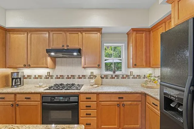 a spacious bedroom with a bed a table and chair