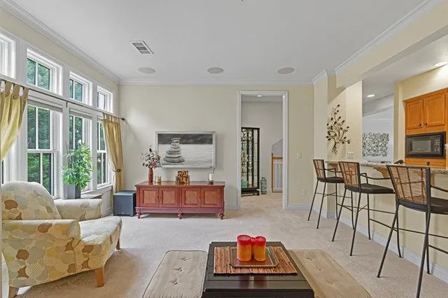 a bedroom with a bed and dresser with mirror