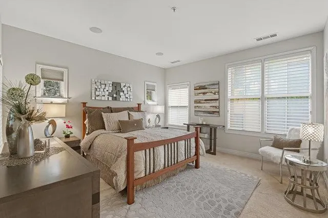 a bathroom with a granite countertop shower sink and mirror