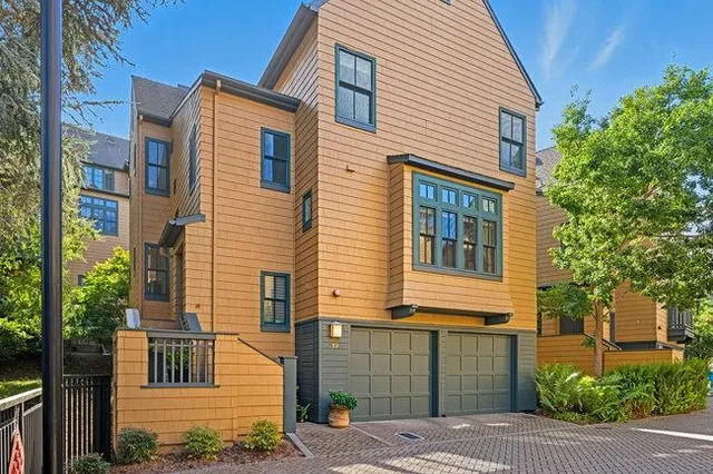 an aerial view of multiple houses with yard