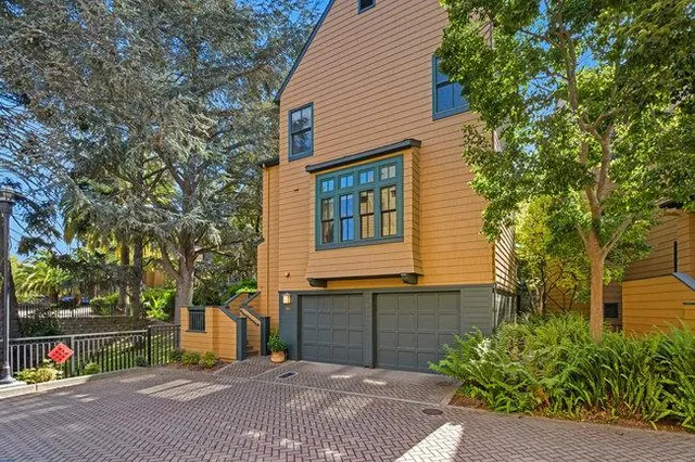 an aerial view of a house with garden space and street view