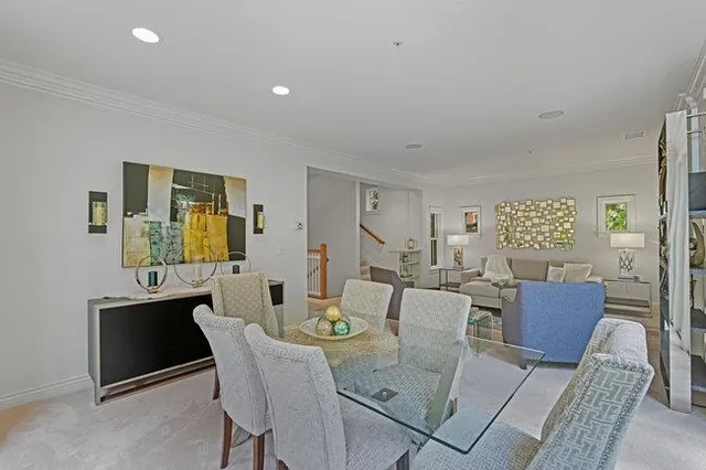 a living room with furniture and large windows