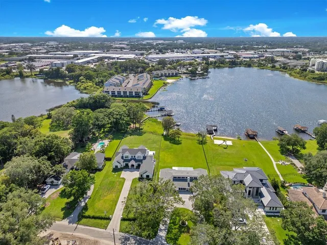 an aerial view of a houses with a lake view