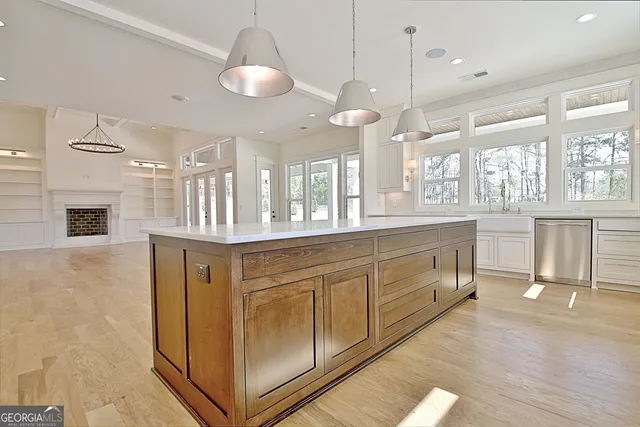 a large white kitchen with a large window