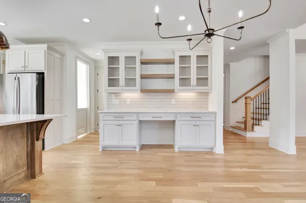 a view of an empty room with a fireplace and a window