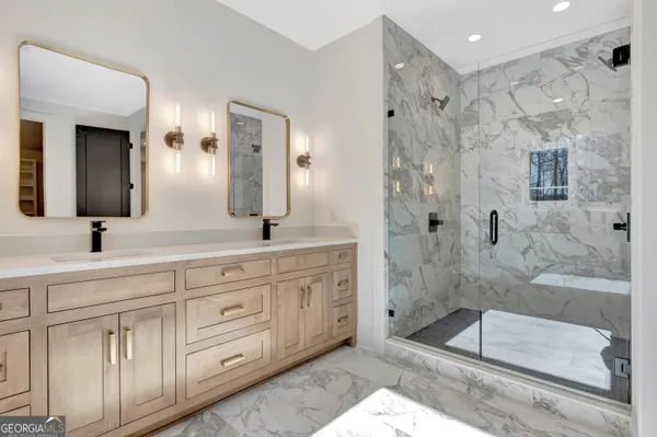 a spacious bathroom with a shower sink and mirror
