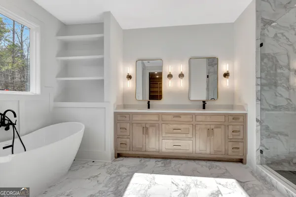 a spacious bathroom with a tub sink and mirror