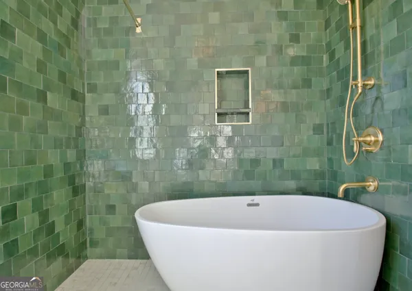 a bathroom with a bathtub and shower