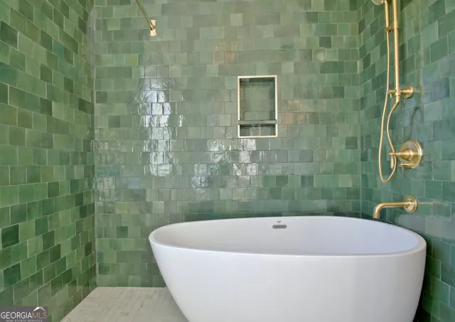 a bathroom with a bathtub and shower