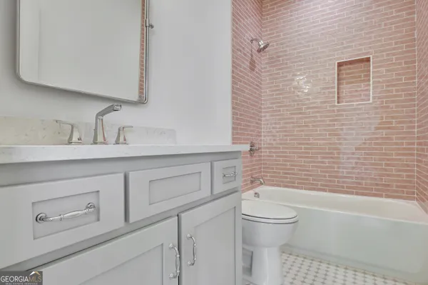 a bathroom with a sink a toilet and a bathtub